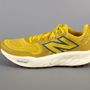 Bright yellow New Balance sneaker with small text reading Fresh Foam along the side of a thick sole.